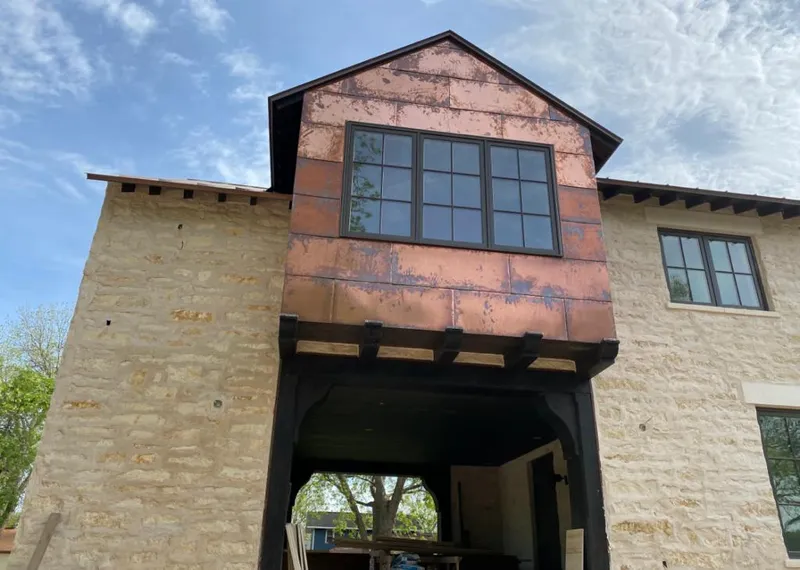 Copper metal panel facade on a stone building for Skylight Installation in Pickerington